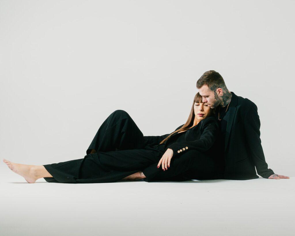 a man and a woman sitting on the floor