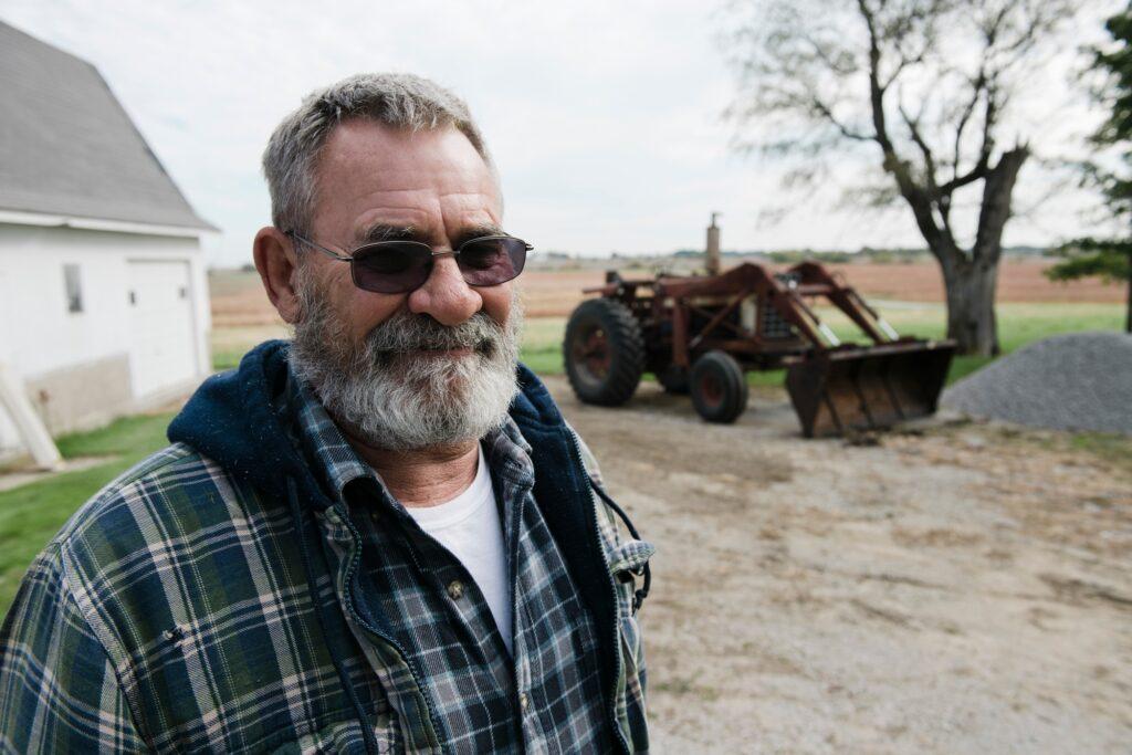 Portrait of senior male farmer in farmyard, Plattsburg, Missouri, USA